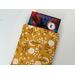 a small book peeking out of the floral book pocket