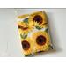 This sunflower book sleeve with pocket has a white background with large sunflowers.