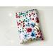 this floral book sleeve has a white background with colorful flowers
