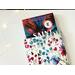 A small book peeking out of the floral book jacket