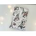 This paris book sleeve has white background with sparkly Eiffel Tower with pink flowers