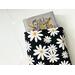 a medium size book peeking out of the daisy book jacket