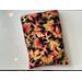 this leaves book sleeve has a black background with fall leaves all over it