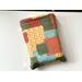 this patchwork book sleeve has fall colors blocks with each color having different prints