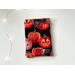 this pumpkin kindle sleeve has a black background with some pumpkins caved out and others covered in sparkly spider web