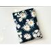 this daisy book sleeve has a navy blue background and the flowers are different size with stems