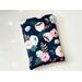 this flower book sleeve has a navy background with pink and light blue flowers and green leaves