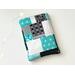 this patchwork book sleeve has blocks of black, gray, white and blue each block having different prints
