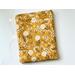 this floral tablet sleeve has a mustard yellow background with dandelions all over the tablet holder