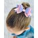 My 4 year old modeling a Lavender & pink glitter 4 layer bow. Top left corner of bow has iridescent pink embellishments.