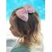 My 4 year old modeling the textured floral inspired soft pink, peach, blue, & yellow, hair bow, with pink sparkle shell charm on top. 
