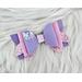Lavender & pink glitter 4 layer bow. Top left corner of bow has iridescent pink embellishments. Bow is approx 4 x 2 & is sold individually. 