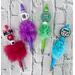 Photo of 5 beaded mama faux fur pens. From left to right: Red, Purple, Green and Blue. Pens are sold individually.