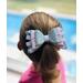 My 4 year old modeling a soft lavender glitter, ribbon, and faux leather hair bow. Bow is sold individually.