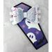 Soft lavender glitter faux leather, with loops of iridescent ribbon, tied in w/ white faux leather w/ pink and lavender pumpkin face print. 