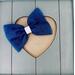 Navy blue 4 x 3 glitter tulle hair bow. Brought together with a piece of white glitter faux leather.  Bow is sold individually.