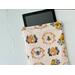 a tablet is peeking out of the bee tablet cover