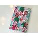 This Christmas book sleeve has a white background red, pink, blue & green hard candy