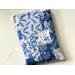 this quilted book sleeve has different shades of blues and white blocks. each block has a different print