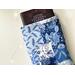 a large book is peeking out of the patchwork book holder