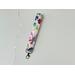 this floral keychain wristlet has a white background with colorful flowers