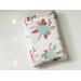 this floral book sleeve has a white background with pink and blue flowers and leaves all over it