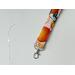 a close up of the orange key chain with a silver lobster claw