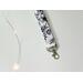a close up of the flower lanyard wristlet with the silver lobster claw