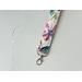 a close up of the floral key strap with the silver lobster claw
