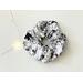 this floral scrunchie has a white background with black flowers