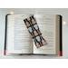 this guitar book mark is on top of an open book