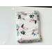 this floral book sleeve has a white wooden background with light pink flowers and light and dark green leaves