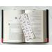 This bookish owl bookmark is on top of an open book