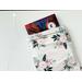 a small book peeking out of the floral book holder
