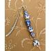 This is also one of my favorite bookmarks.  The white ceramic beads with royal blue flowers is stunning.  This has the lightweight shepherd hook but also has a larger bead directly in the middle of bead with a theme to it. Charm is at bottom.