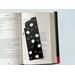 this flower book mark is on top of an open book