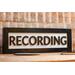 black wood recording studio LED light up lightbox and lamp sitting on desk for home studio, podcasters, musicians, and gamers
