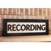 black wood recording studio LED light up lightbox and lamp sitting on desk for home studio, podcasters, musicians, and gamers