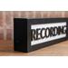 side view black wood recording studio LED light up lightbox and lamp sitting on desk for home studio, podcasters, musicians, and gamers