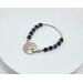 Bracelet with handcrafted round pewter focal clasp and diamond cut blue lapis beads and pewter accents with a silver tube opposite the focal