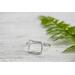 Sterling silver ring with open square design.