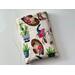 this western book sleeve has a light brown background with cowboy hats, boots, cacti & bulls all over the book protector