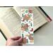 there are cowboy boots, hats, cacti, & small brown flowers all over the page saver. The book mark is laminated
