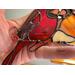 Close up of copper wire branch on Cardinal Ornament.