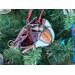 Close up on Cardinal Ornament hanging in a Christmas Tree.