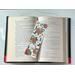this cowboy bookmark is in the middle of the open book with fairy lights above the book