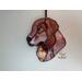 Golden Retriever Ornament hanging on a wall.