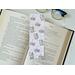 the cute book placeholder is on top of an open book with a pair of glasses above & fairy lights on the right side on a white table