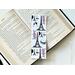 This French bookmark has a white background with the Eiffel Towers, some food all in black. And in colors blue and red is the words Paris and Bonjour