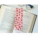 red bookmark has a light red background with different shades of red flowers, leaves and polka dots